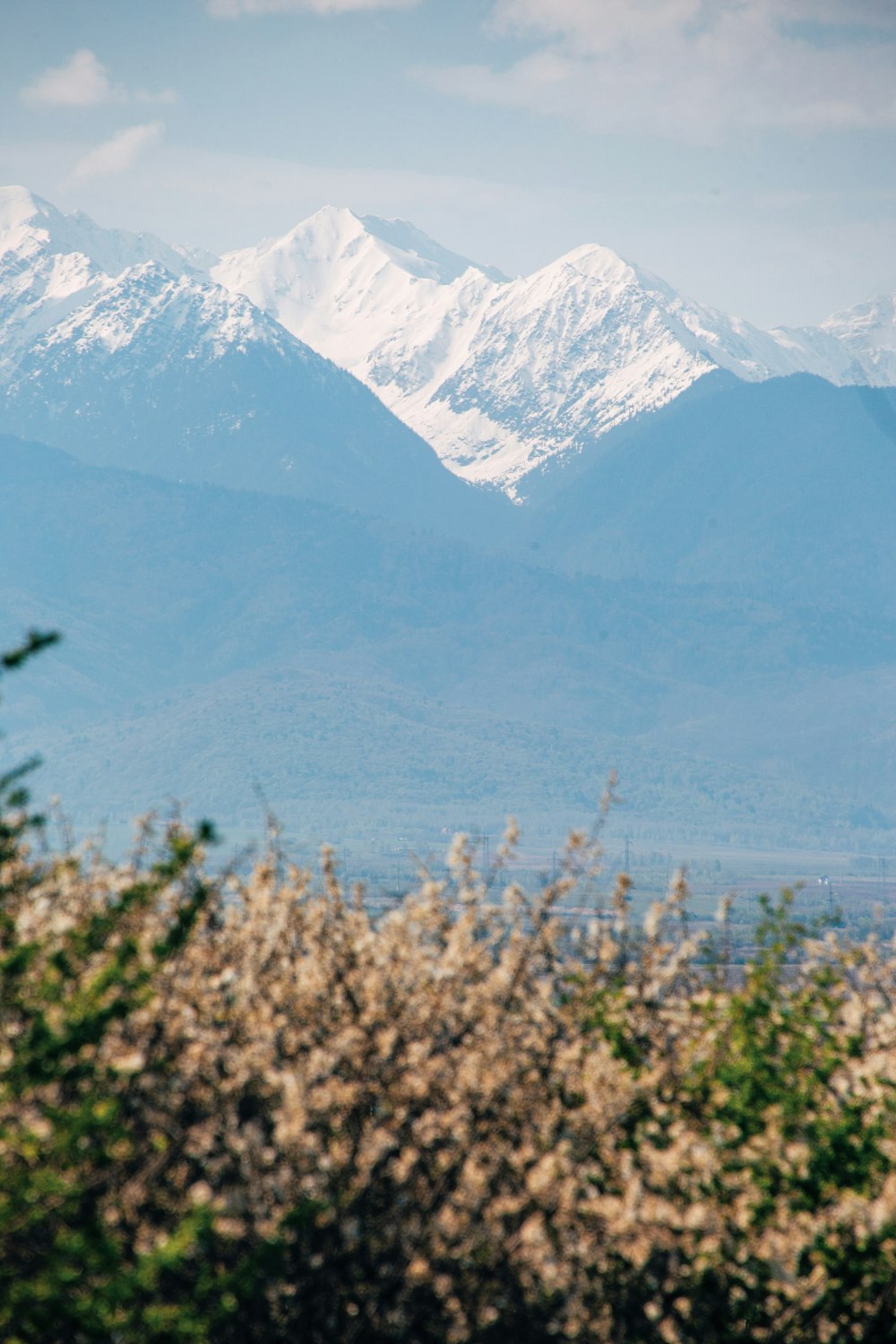 a mountain range with snow capped mountains in the background