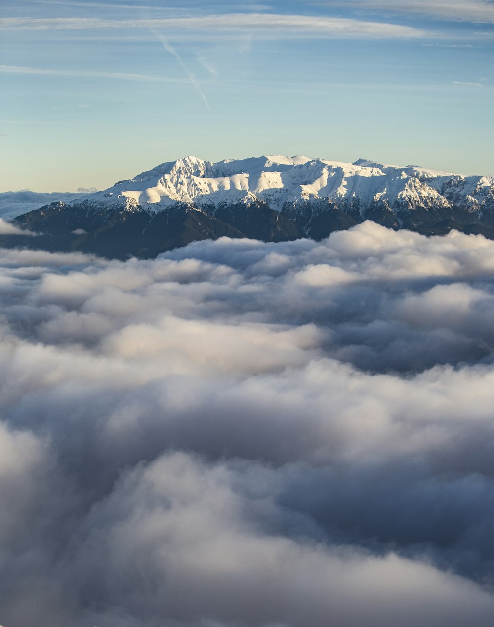 a view of a mountain covered in clouds