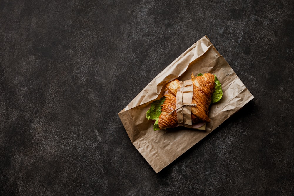 a sandwich on a piece of paper on a table