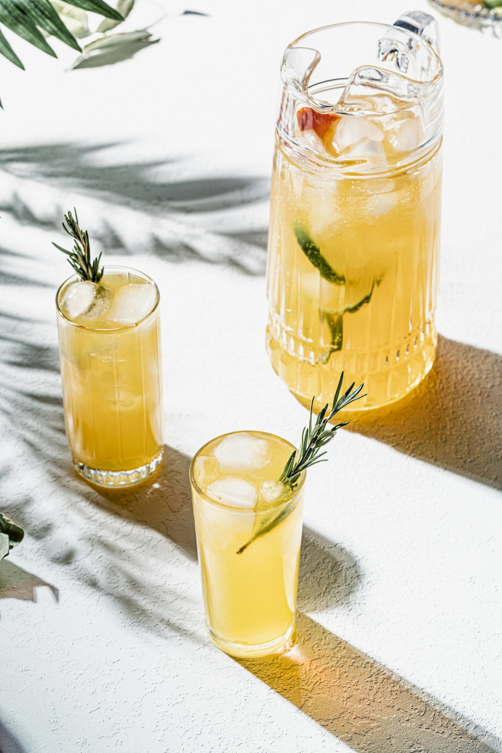 two glasses of lemonade sit on a table