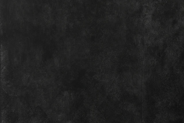 Close view of a dark, worn metal surface