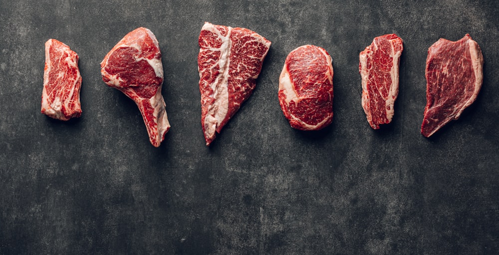 a group of raw meats laid out on a table