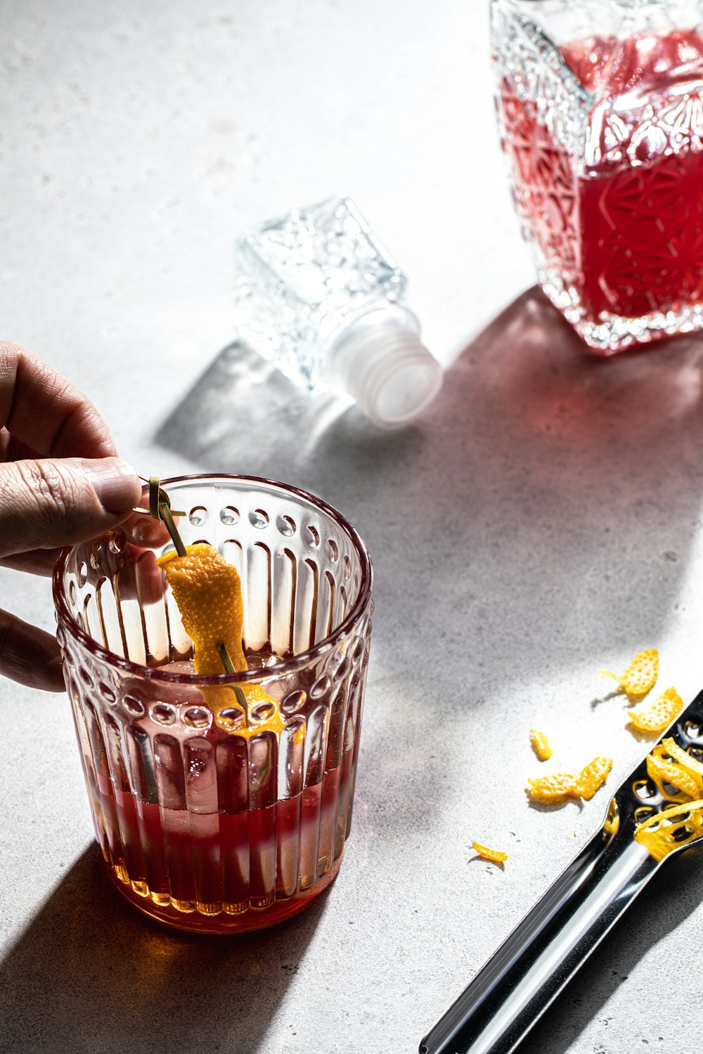 a person holding a piece of food in a glass