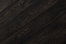 Dark wood planks with visible grain patterns and subtle variations in tone create a sleek and elegant texture.