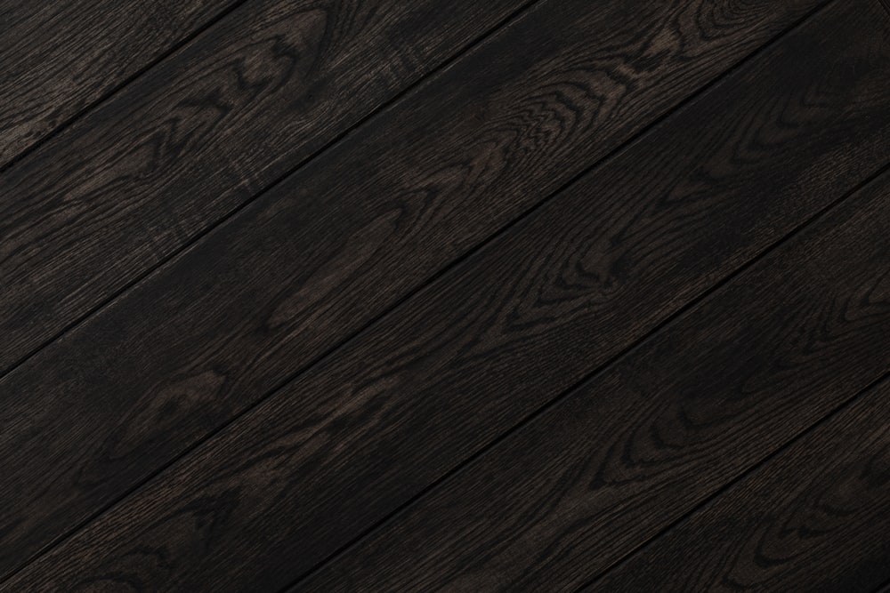 a close up of a wooden floor with dark wood