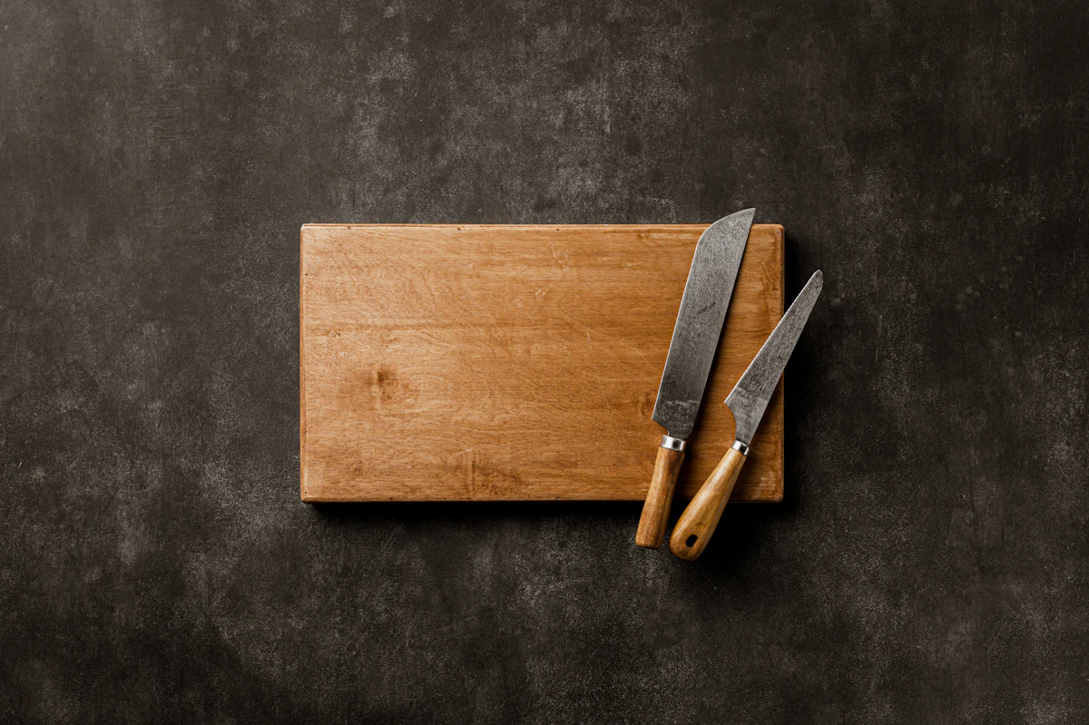 Wooden cutting board and knives representing a traditional fifth anniversary gift