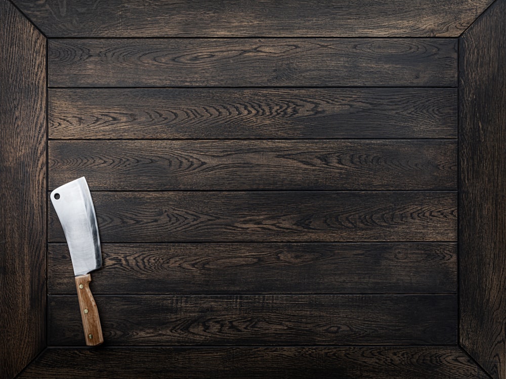 a knife sticking out of the side of a wooden door