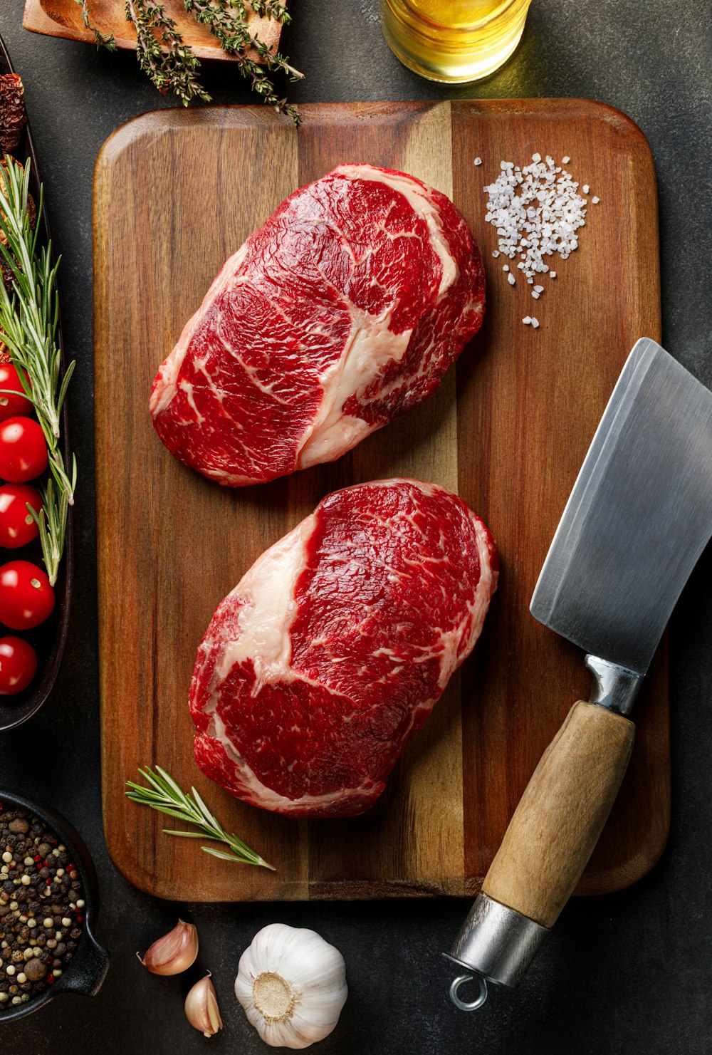 a couple of raw meat on a cutting board