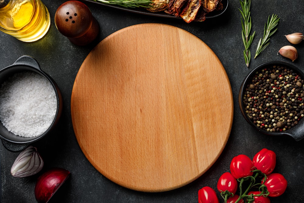 a wooden cutting board surrounded by various ingredients