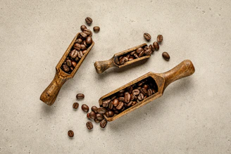 A cozy coffee box with two scoops of rich coffee beans spilling gently onto a wooden table.