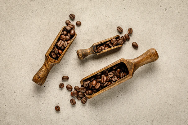 A cozy coffee box with two scoops of rich coffee beans spilling gently onto a wooden table.