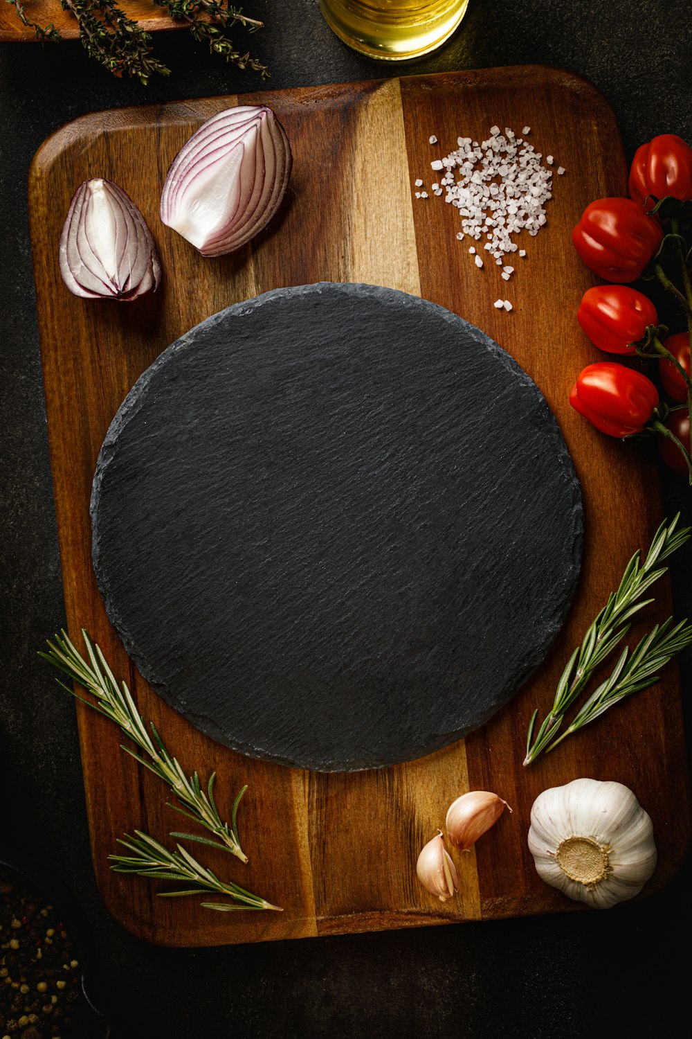 a wooden cutting board topped with a black stone