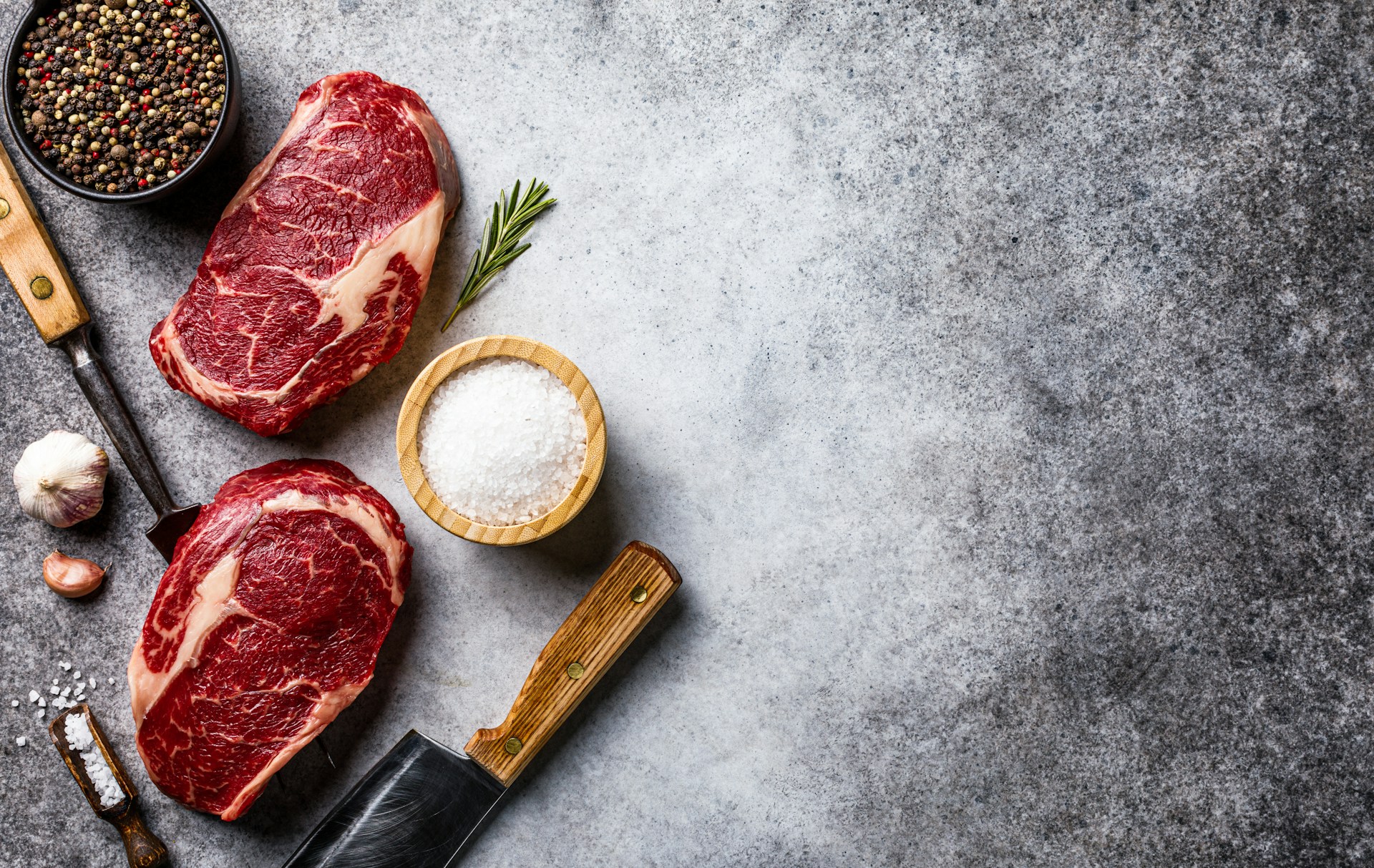 raw meat on a table with spices and seasoning