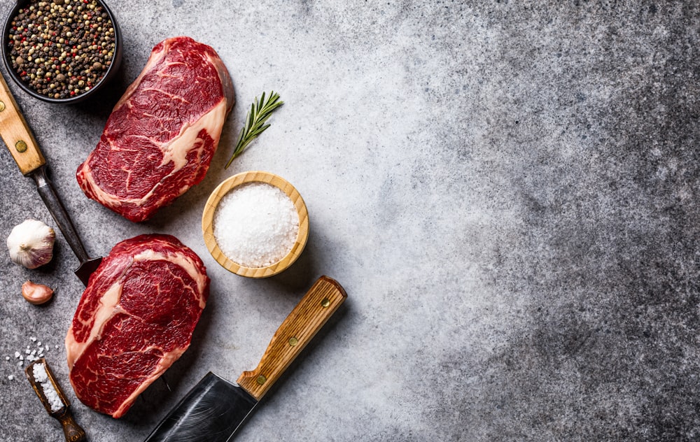 raw meat on a table with spices and seasoning