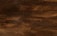Dark wooden planks arranged horizontally with a textured surface, displaying a rich brown tone with subtle variations and natural grain patterns.