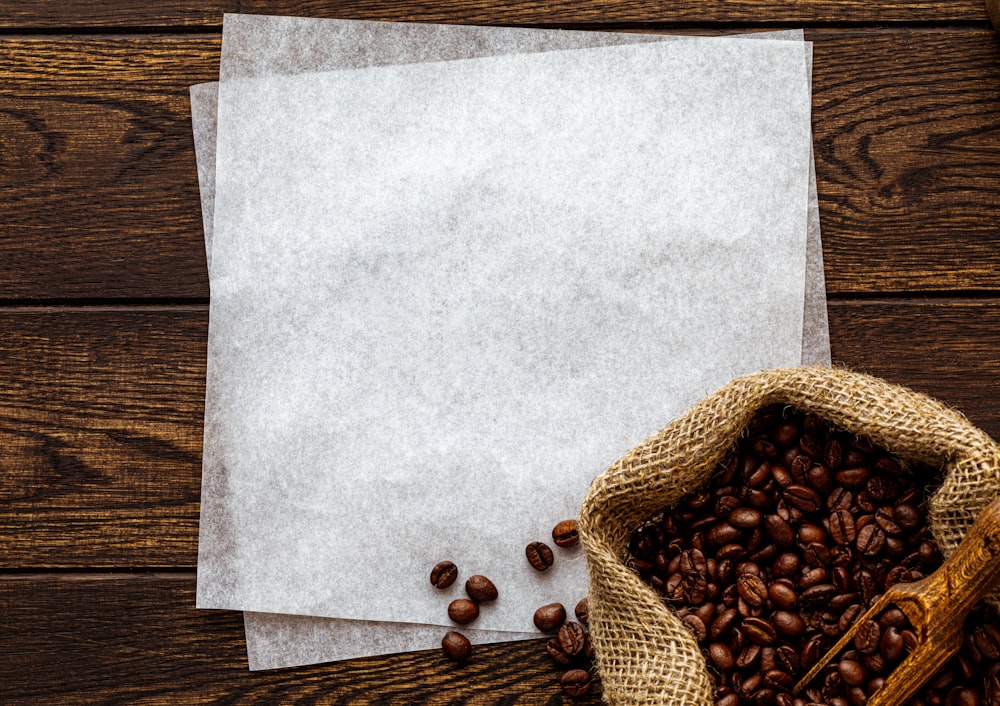 a sack of coffee beans next to a piece of paper