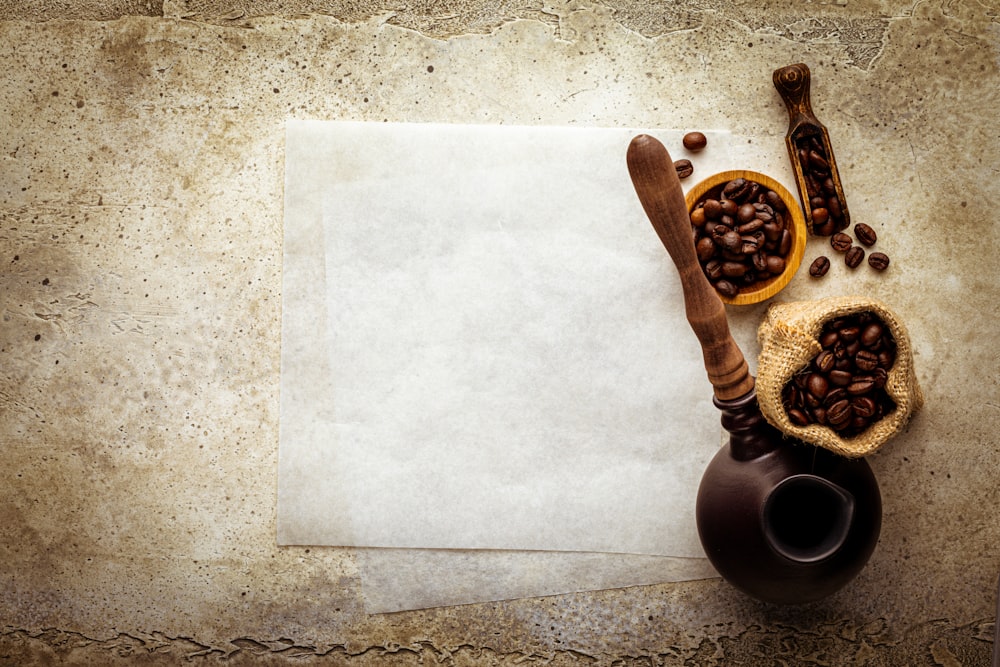 a table topped with a brown vase filled with coffee beans