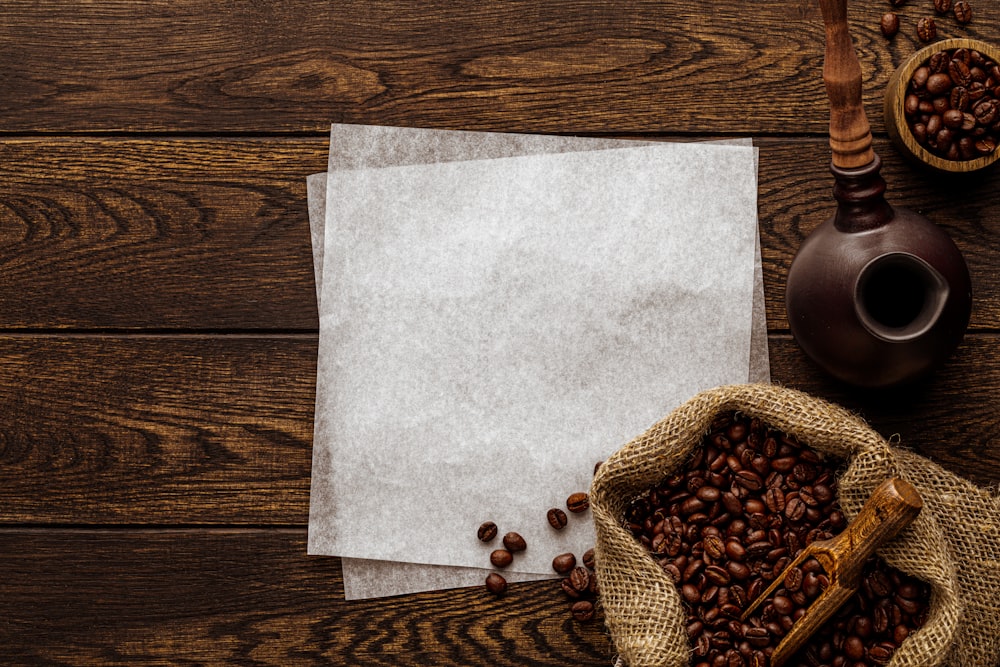 a wooden table topped with two bags of coffee beans