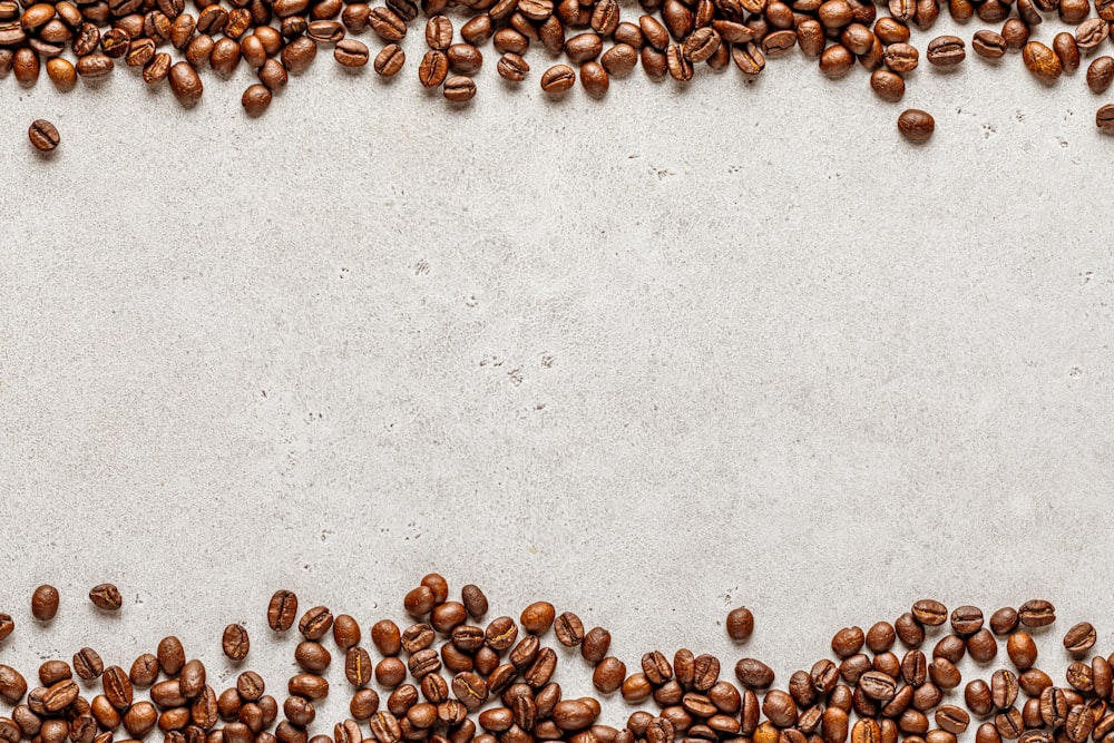 a group of coffee beans on a white surface