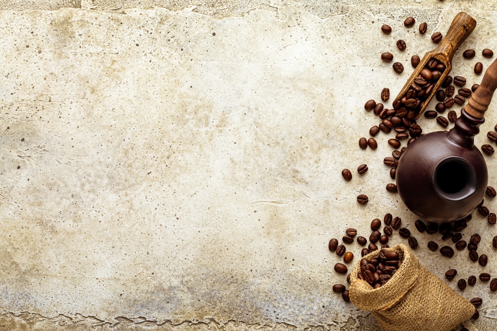 a bag of coffee beans next to a cup of coffee