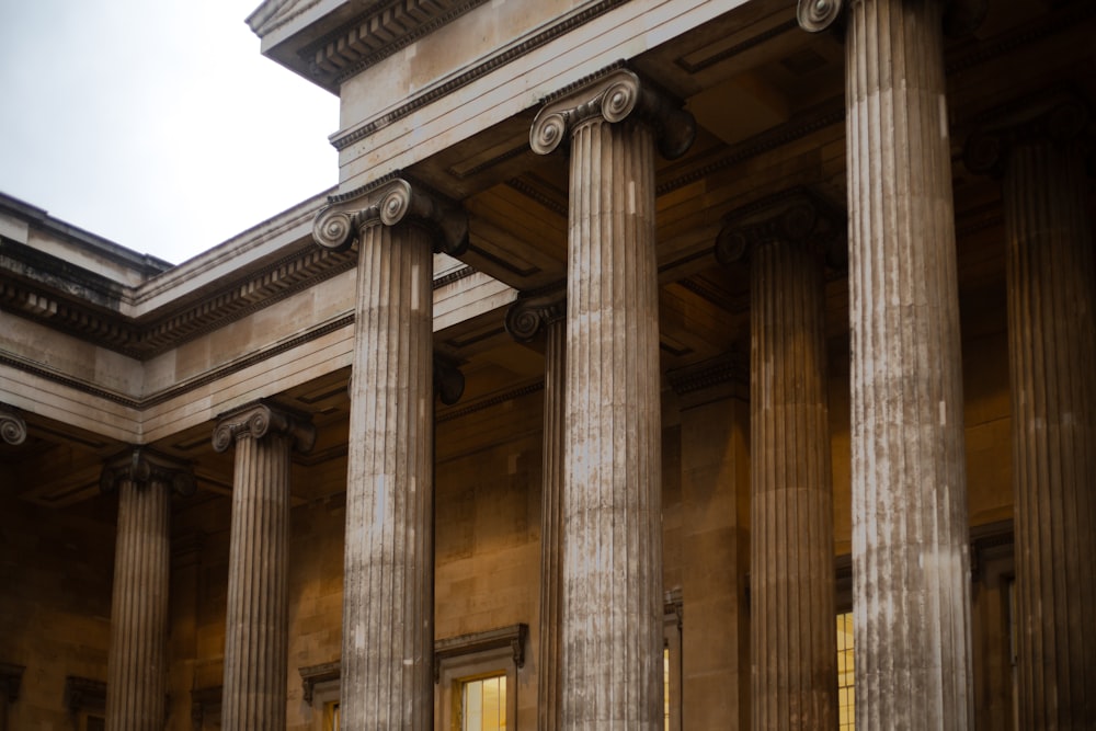 a large building with columns and a clock on the side of it