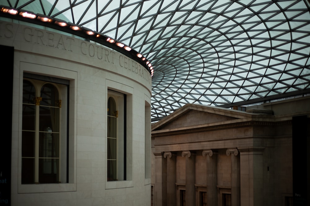 a building with a glass roof and a building with columns