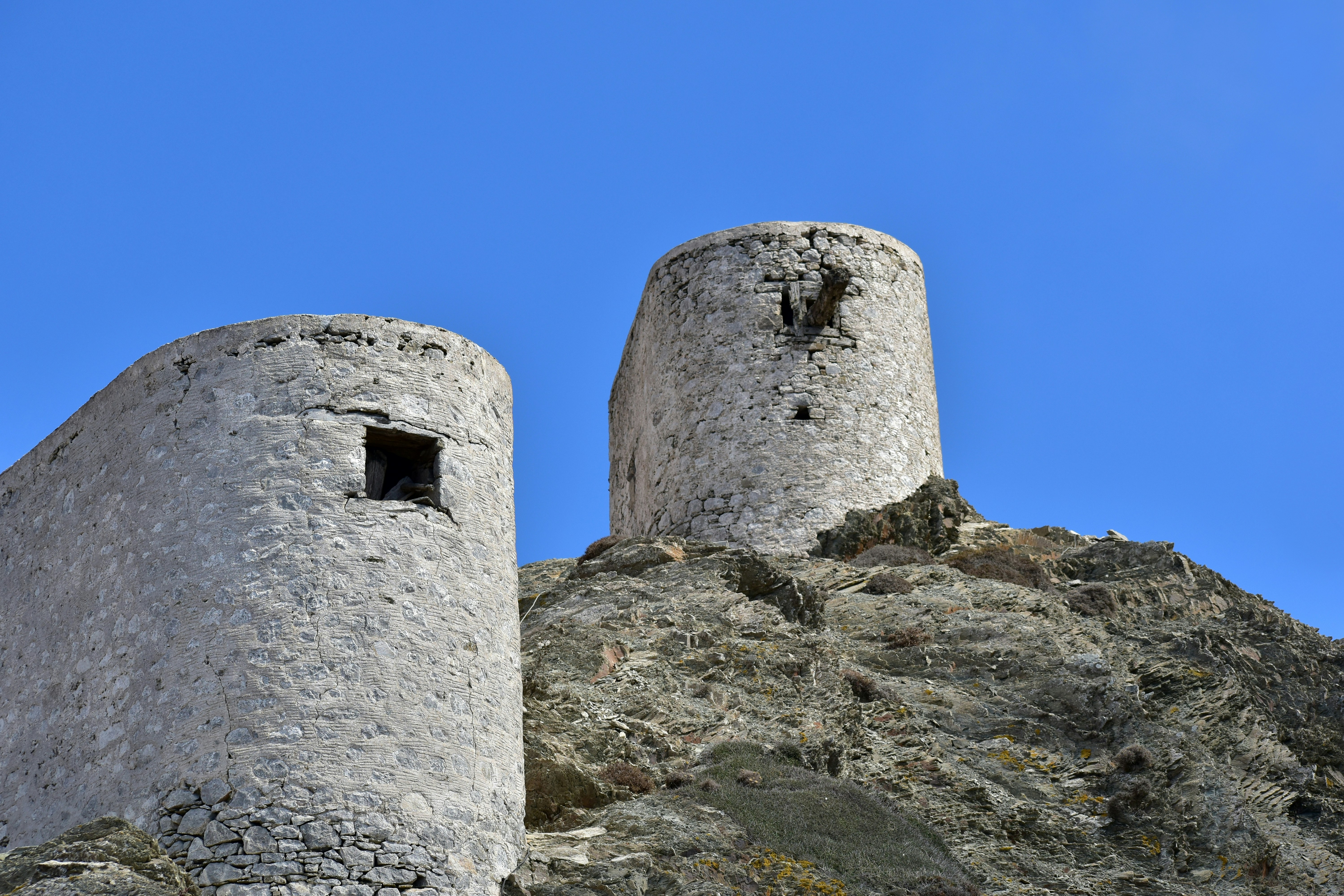 a couple of stone towers on top of a mountain