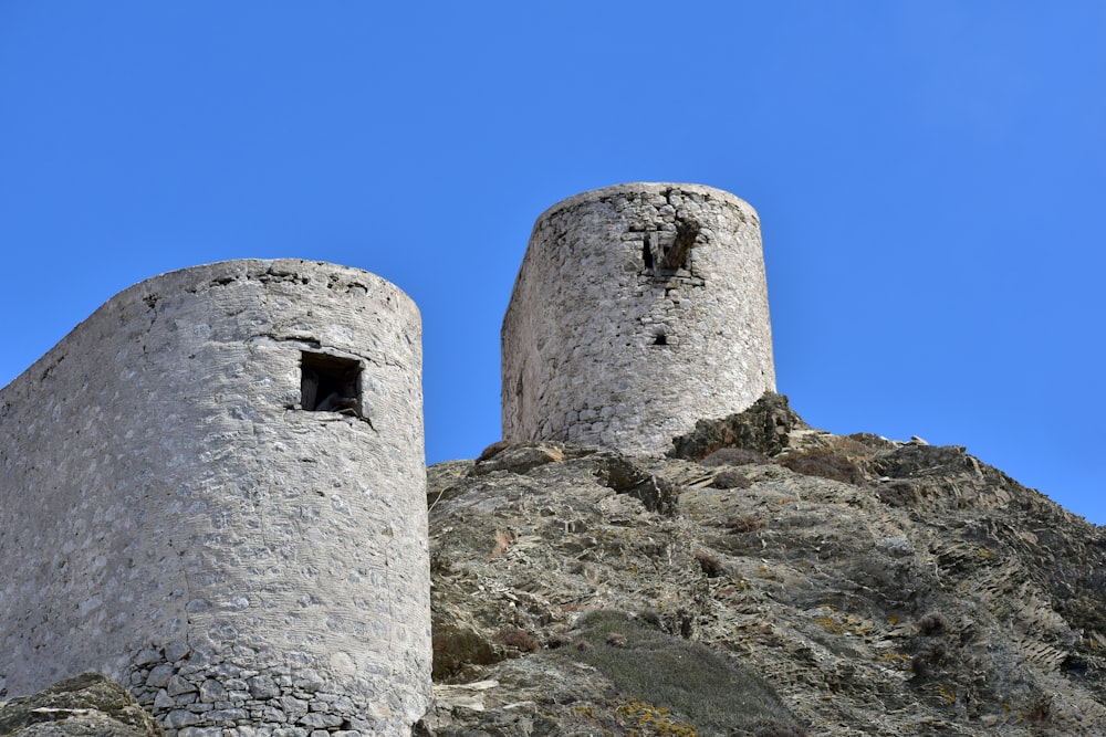 a couple of stone towers on top of a mountain