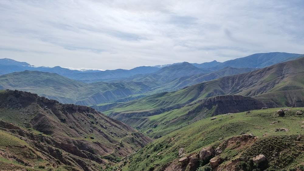 a view of a valley with mountains in the background