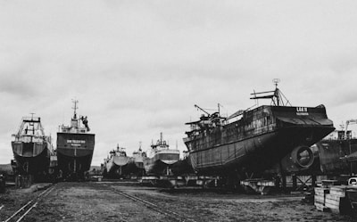a black and white photo of several large ships