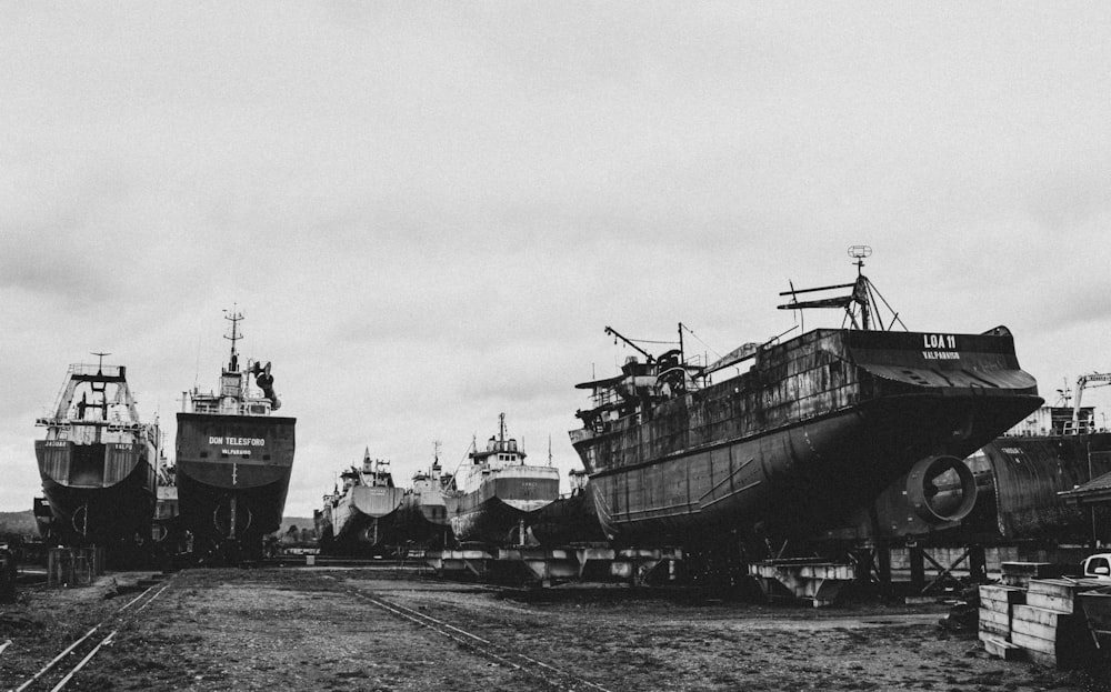 a black and white photo of several large ships
