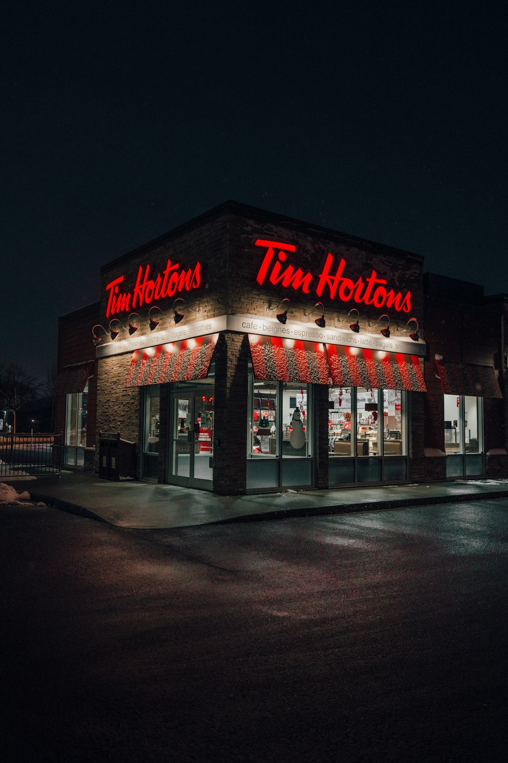 a tim hortons store lit up at night