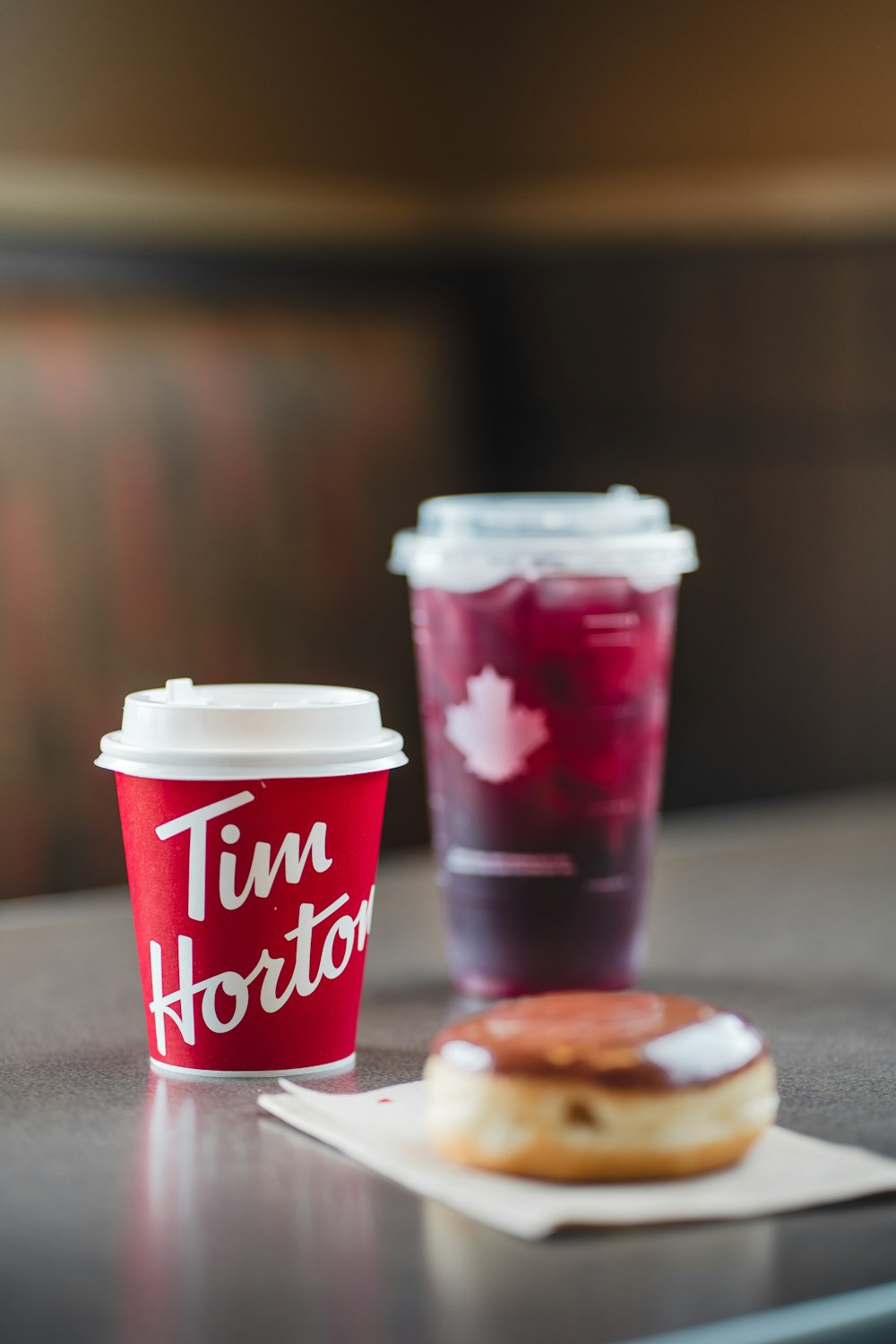 a cup of coffee and a doughnut on a table