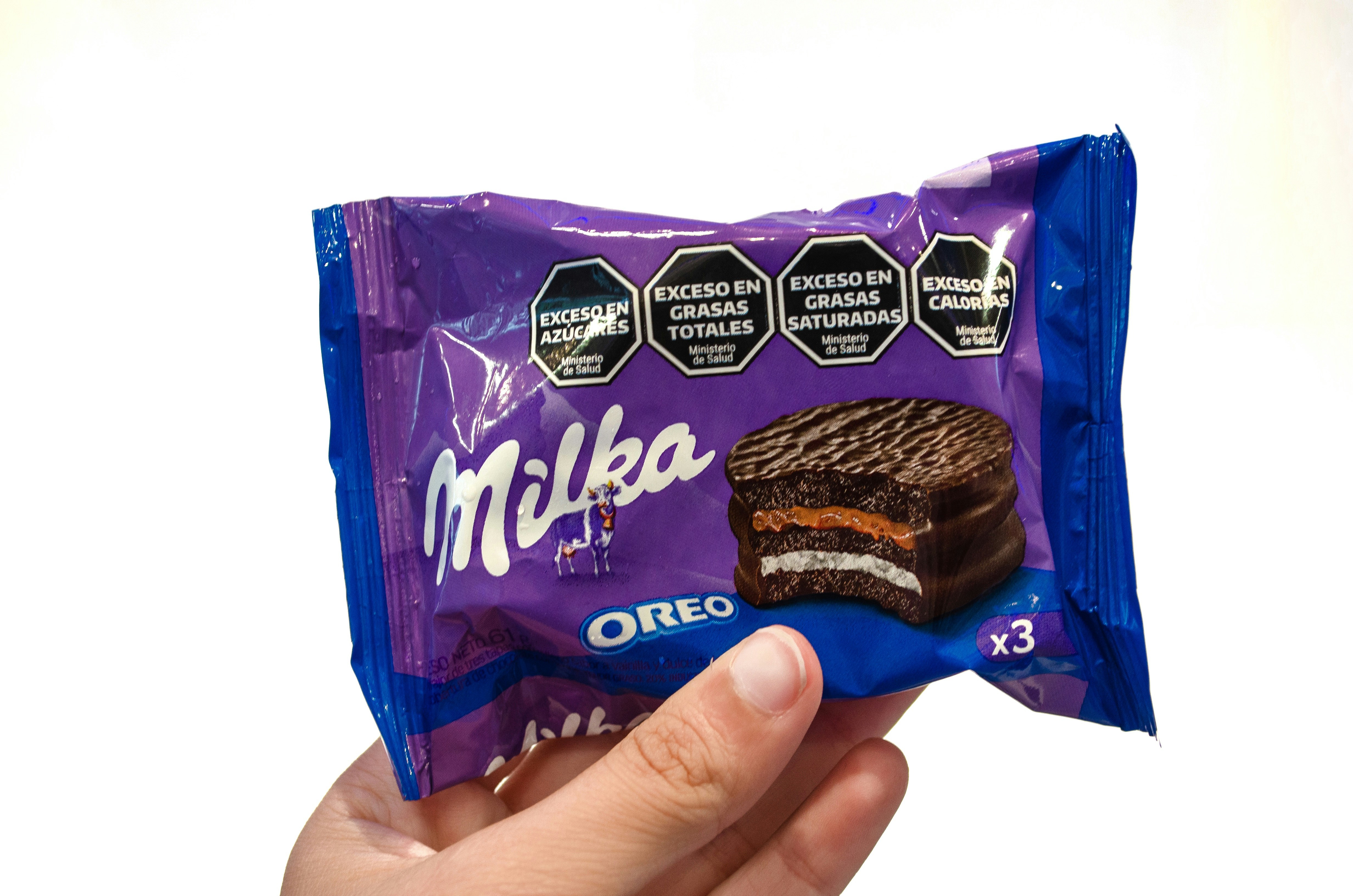 a hand holding a bag of milk chocolate sandwich