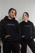 A mother and child wearing matching veteran-themed hoodies with heartfelt slogans.