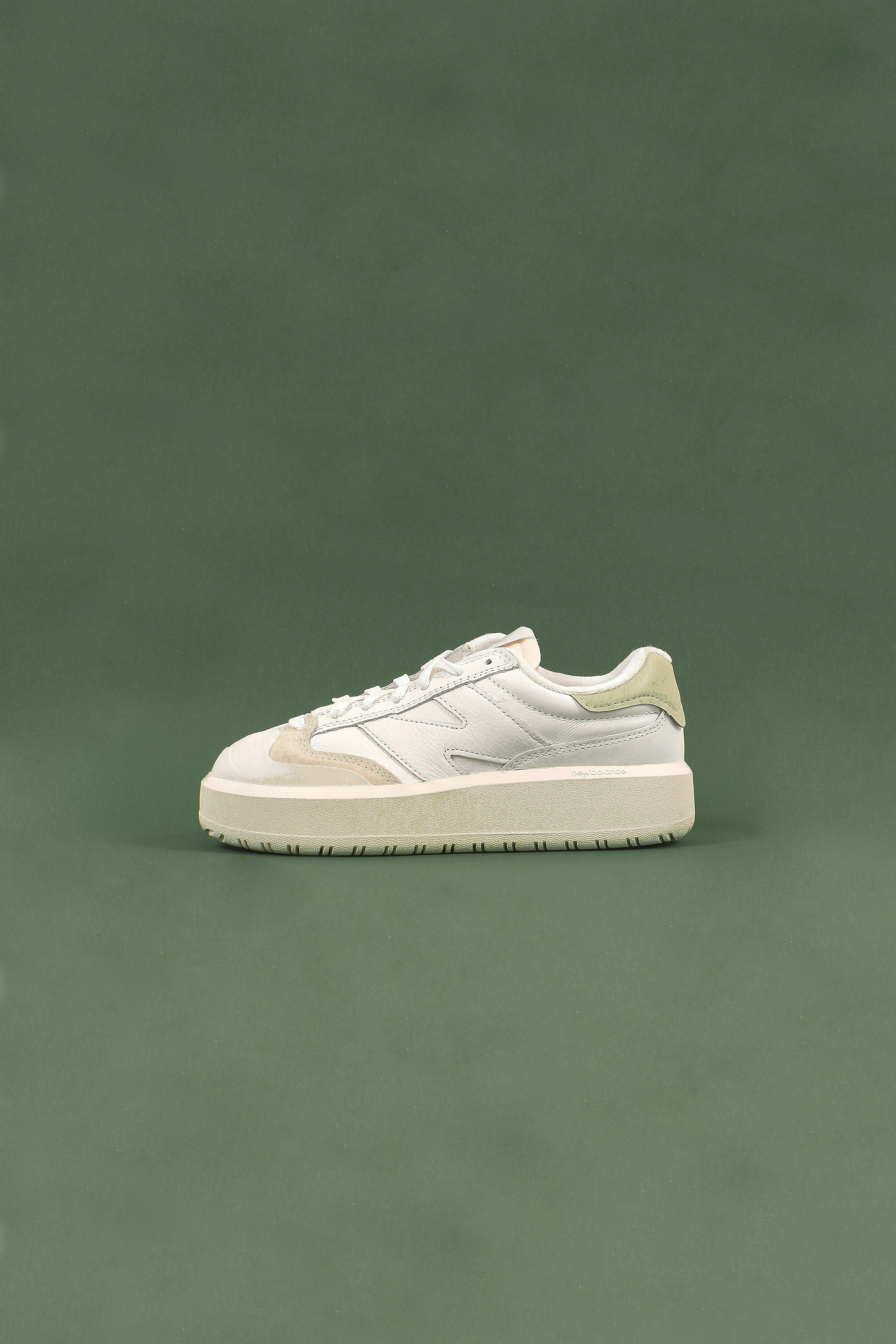 a white tennis shoe on a green surface