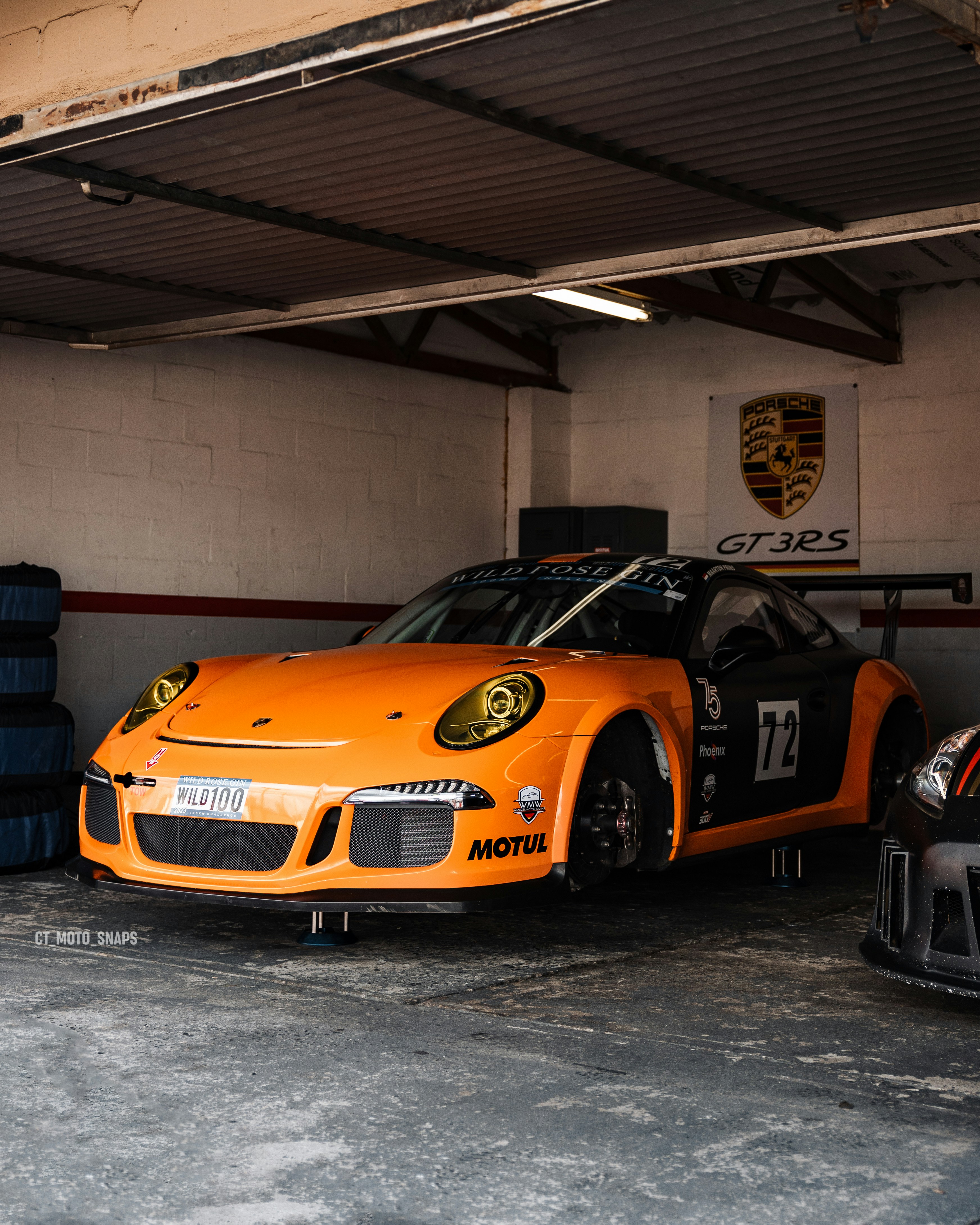 an orange sports car parked in a garage