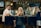 A stylish bar scene with patrons enjoying drinks in a cozy setting.