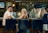 A stylish bar scene with patrons enjoying drinks in a cozy setting.