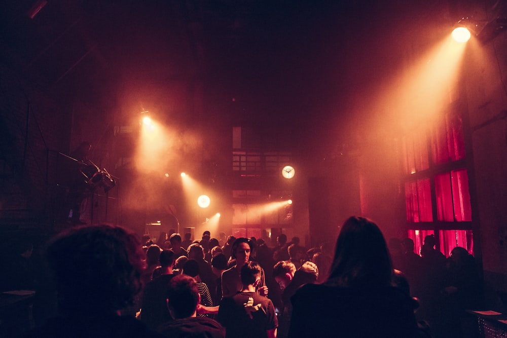 a group of people standing in a dark room