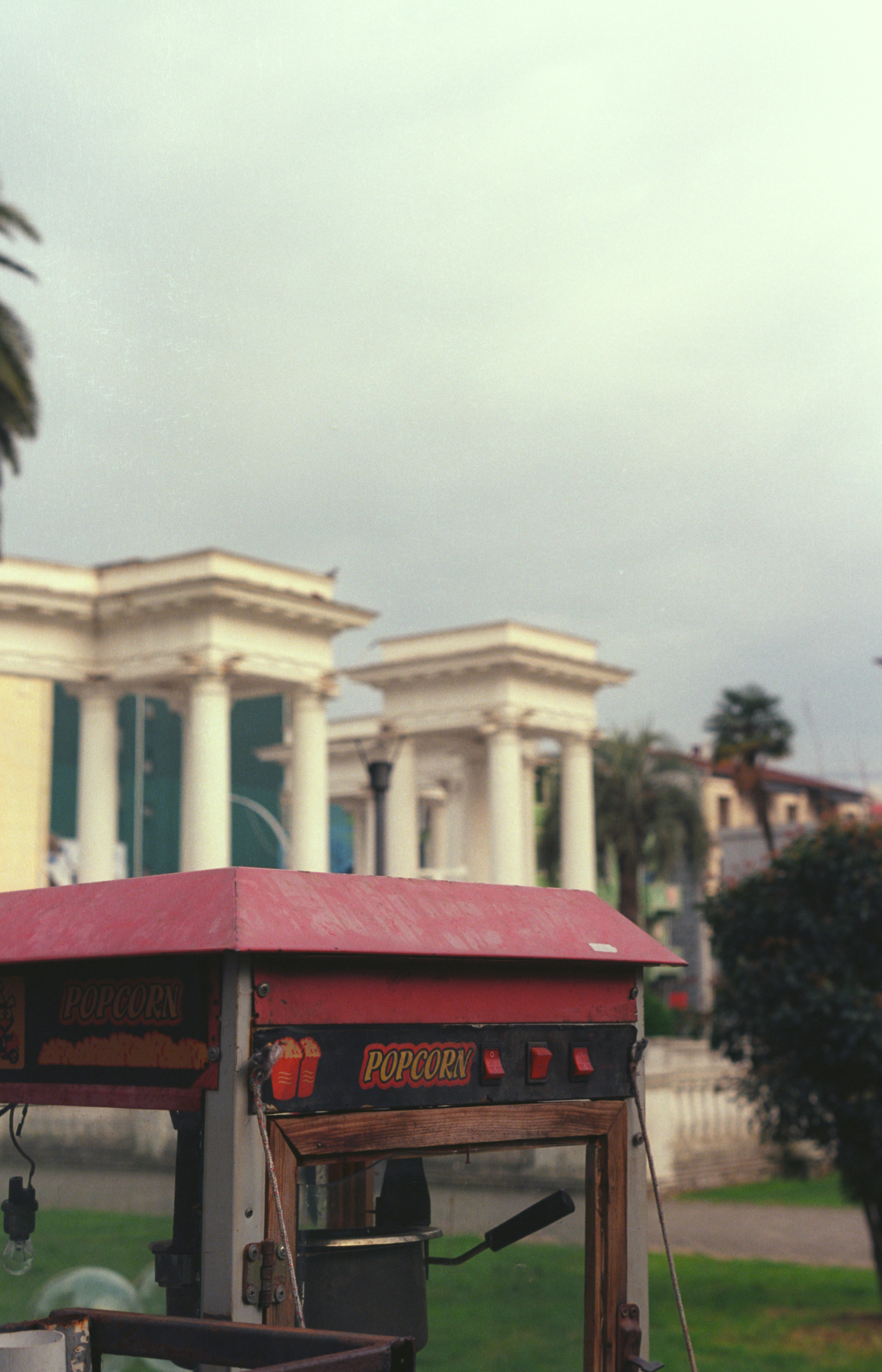 a red covered cart parked in front of a building