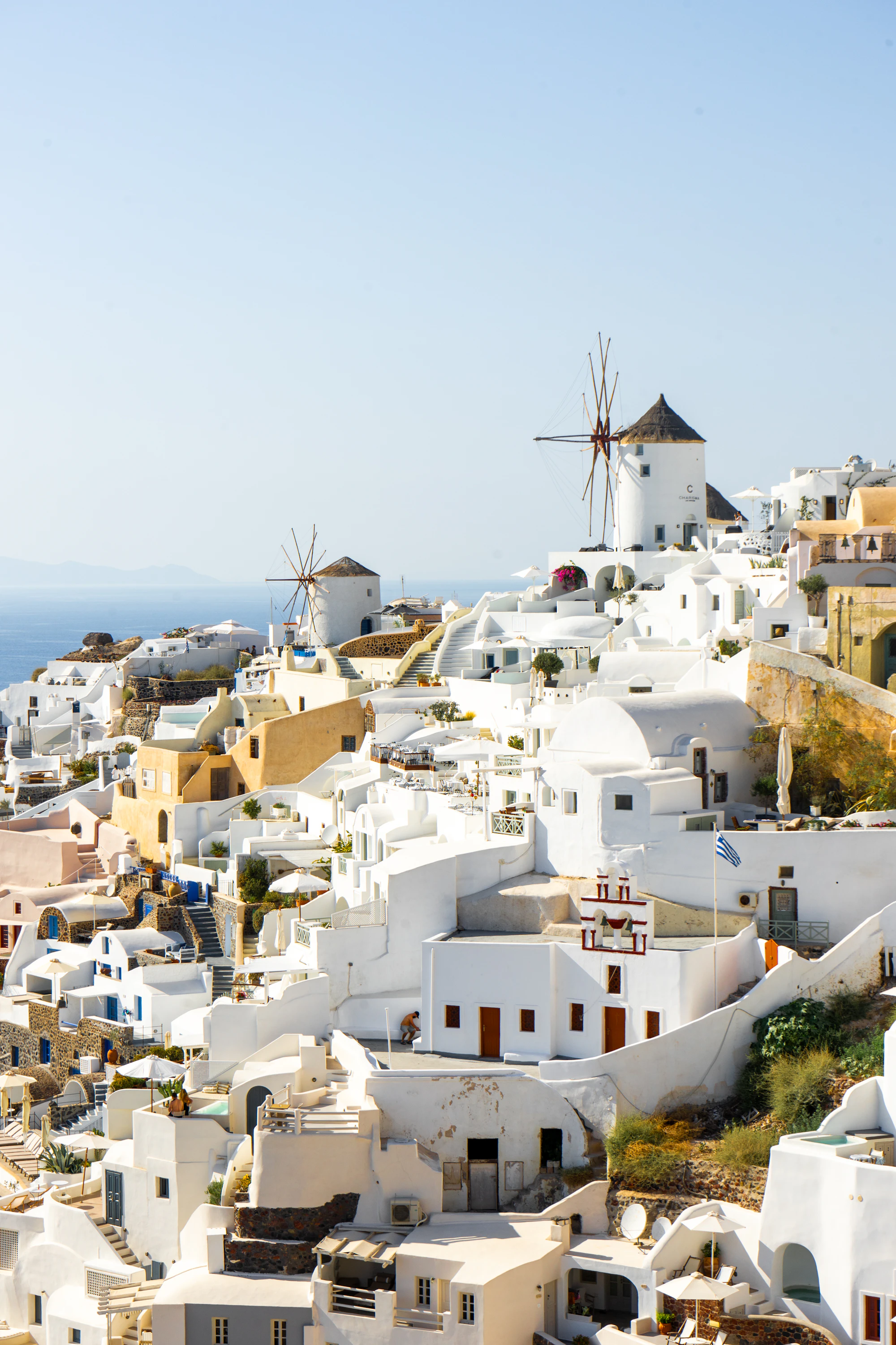 A village with windmills in the background