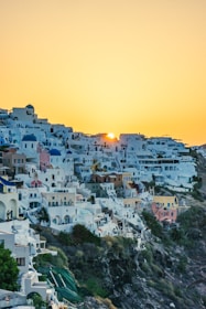 Vibrant street scene in a colorful Greek village with whitewashed buildings and blue domes.
