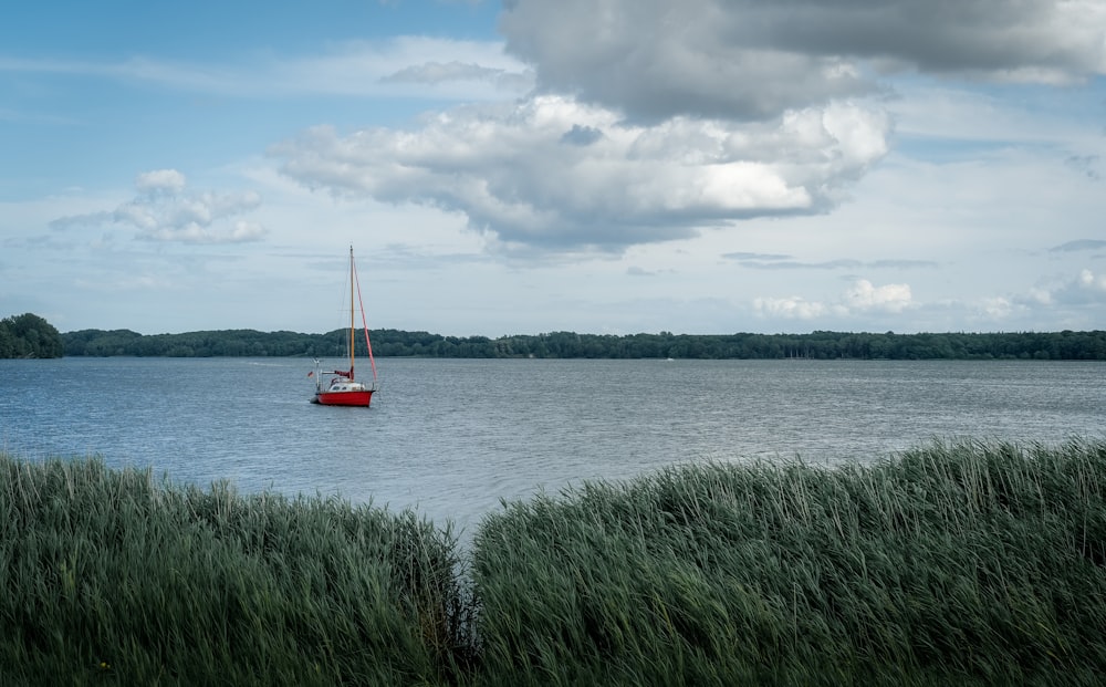 a sailboat floating on a large body of water