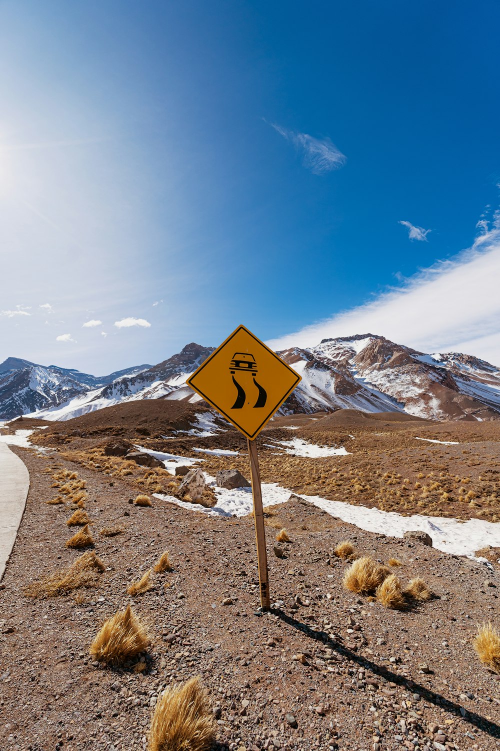 a yellow road sign sitting on the side of a road