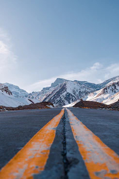 a yellow line on a road in the mountains