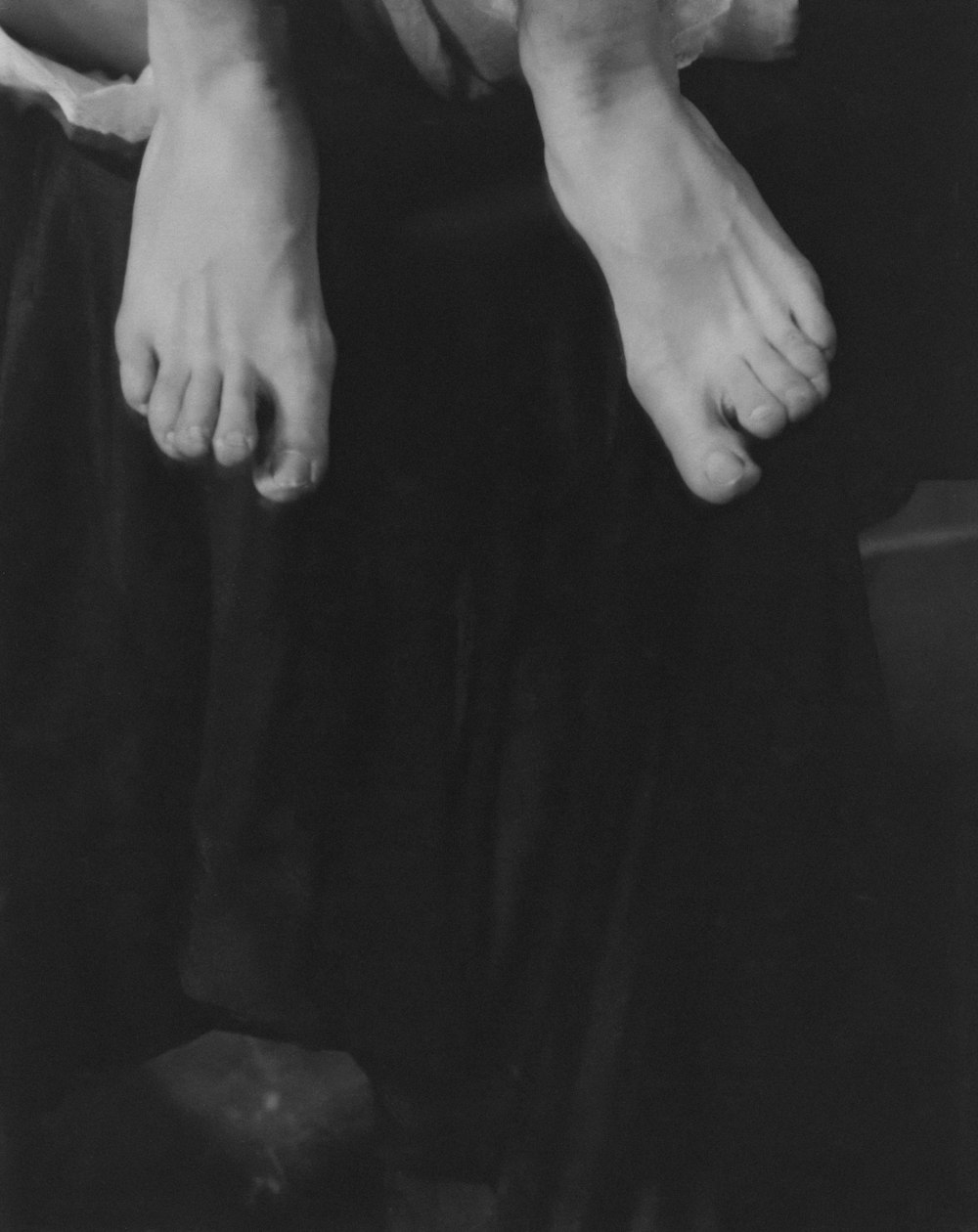 a black and white photo of a person's bare feet