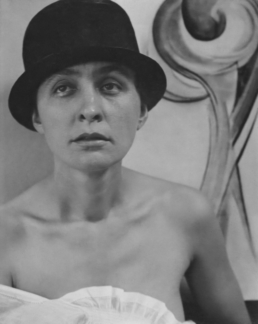 a black and white photo of a woman wearing a hat