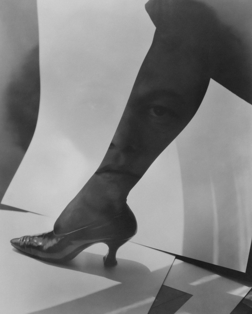 a black and white photo of a high heeled shoe