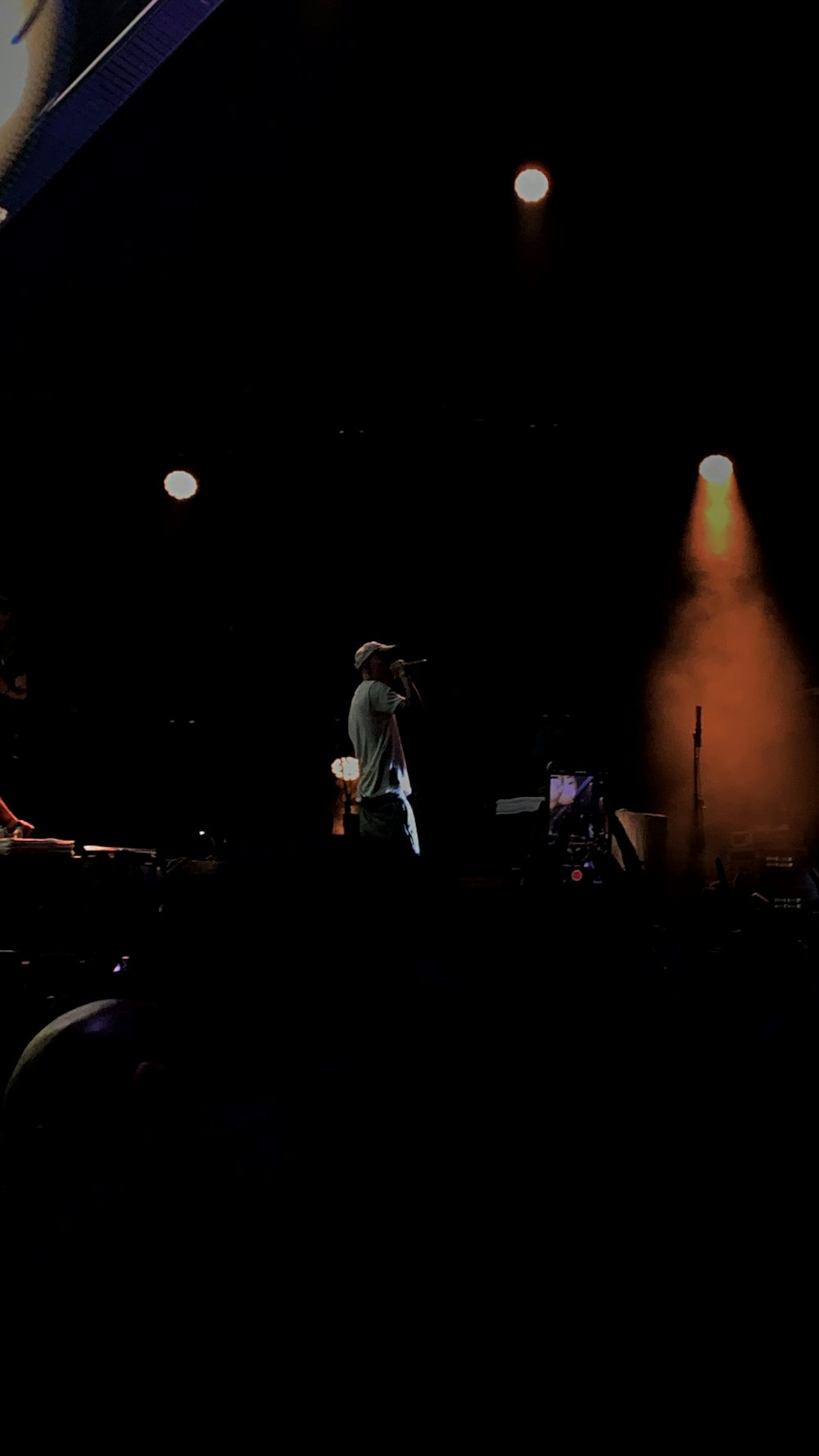 a man standing on top of a stage in front of a crowd